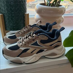 Reebok Royal Charge Y2K sneakers in brown leather and navy blue accents.